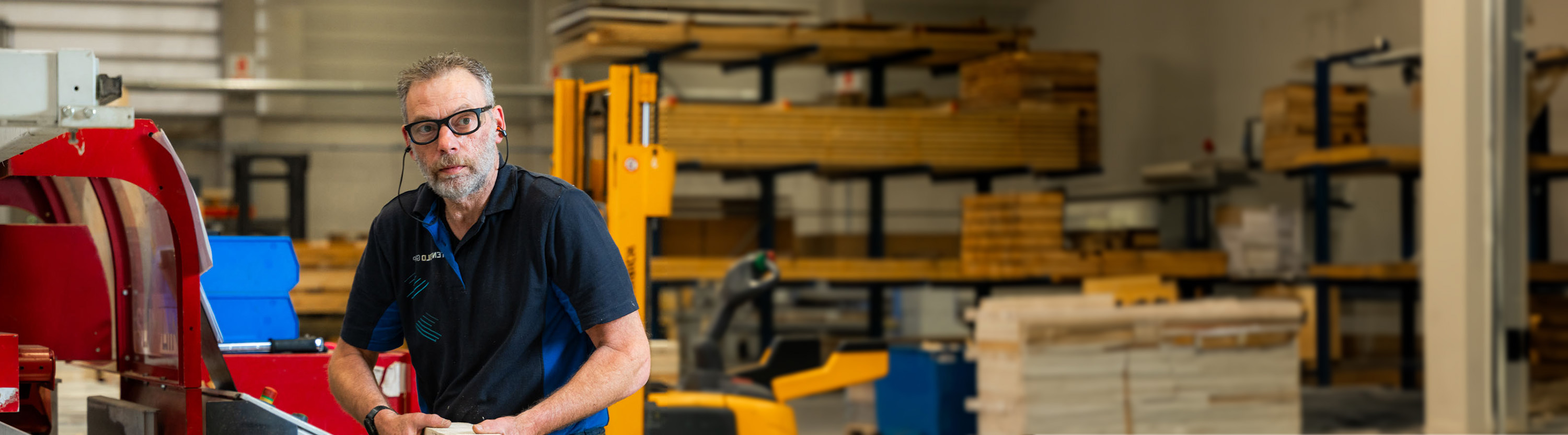 Productiemedewerker bewerkt hout met machine in werkplaats
